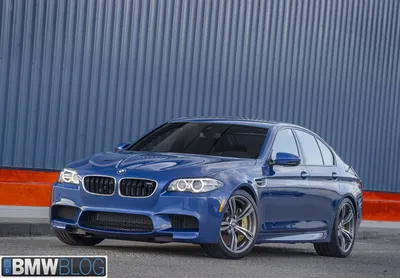 A high-quality real-looking sharp photo of a sleek widebody bmw m5 f10  parked in an upscale environment on Craiyon