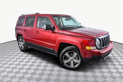 2016 red jeep patriot in front of the ocean on Craiyon