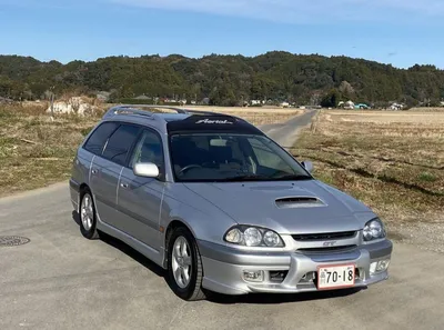 Side View of Toyota Caldina Car of 2000 Release in the Back of a Silver  T210 Station Wagon in a Parking Lot with a Green Lawn Editorial Stock Image  - Image of
