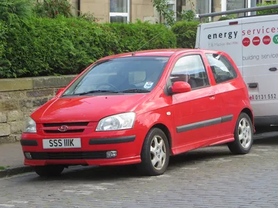 Hyundai getz car parked outside a cat cafe on Craiyon