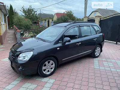 Kia Carens 2.0 CRDi, model year 2006-, silver, driving, diagonal from the  front, frontal view, country road Stock Photo - Alamy