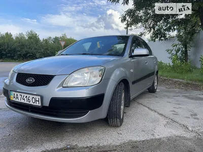 Kia rio hatchback 2006, 5 door, modified with matt black paint and black  rims and spoiler on Craiyon