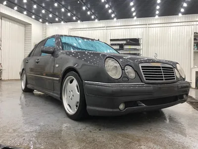 A mercedes benz w210 with lowered suspesion and a widebody kit on Craiyon