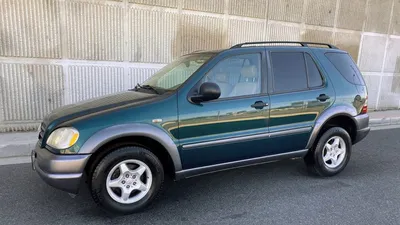 Car, Mercedes ML 320 CDI, model year 2005-, silver, cross country vehicle,  driving, diagonal from the back, rear view, side view Stock Photo - Alamy