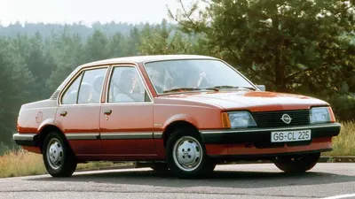 Mir, Belarus - September 1, 2016: Old rusty sedan car Opel Ascona C (1981- 1988) parking in green grass on old wooden house background Stock Photo -  Alamy