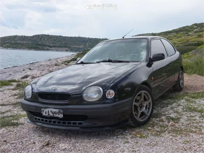 Modified matte black 1998 toyota corolla, lime green racing stripe, with  round circular headlights, hd, parked on Craiyon