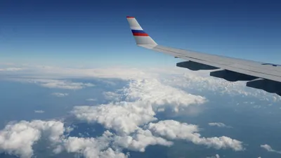Вид из окна самолёта. Облака. Земля. Stock Photo | Adobe Stock